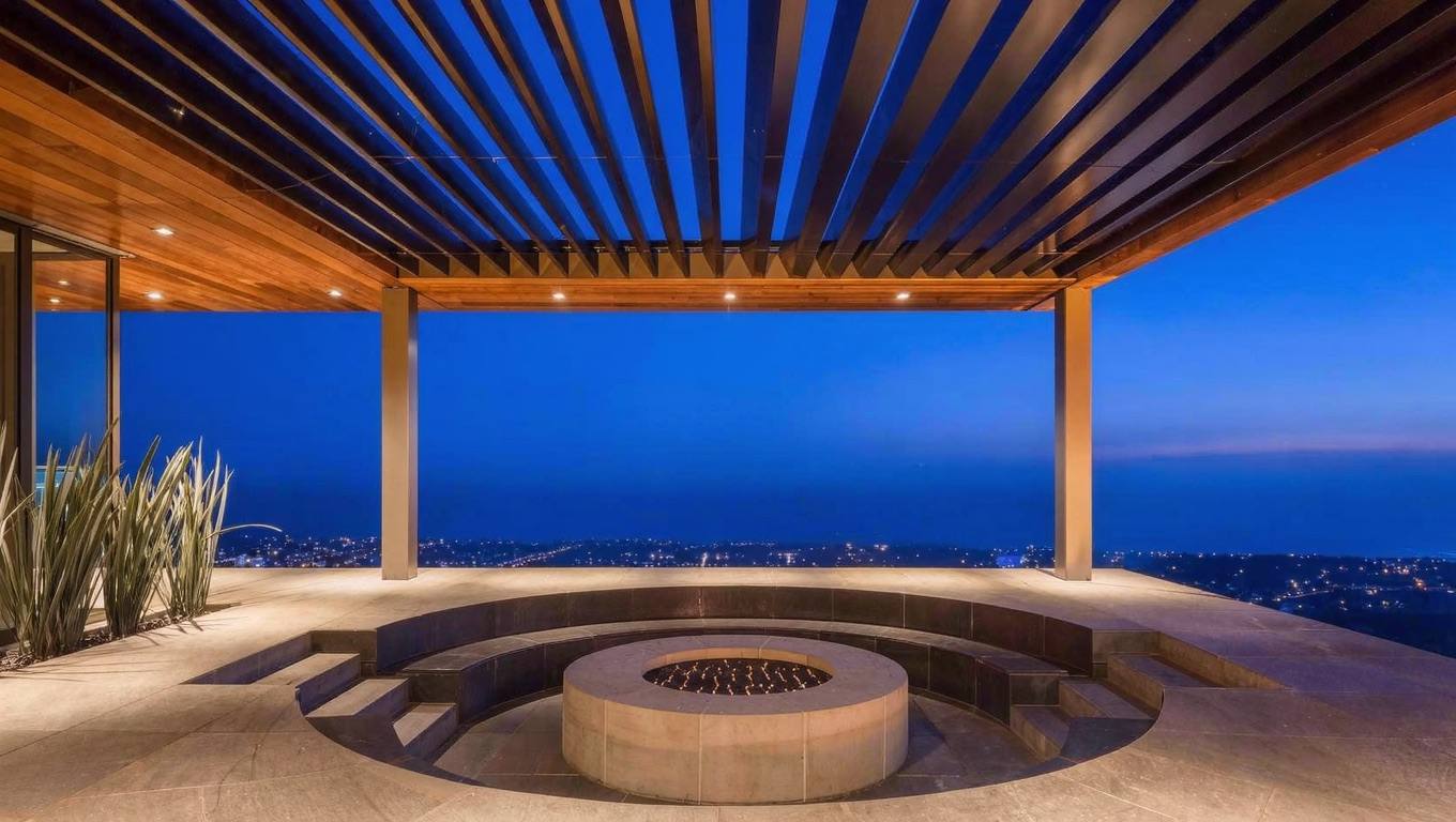 Aluminum louvered pergola and fire pit with ocean view at dusk
